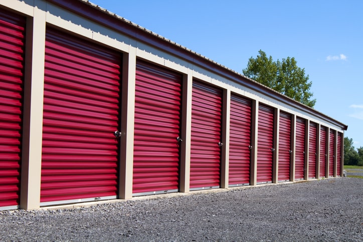 A row of storage units with red doors.