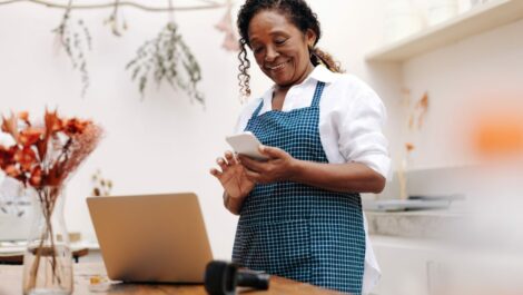 florist reading positive online reviews for her small business