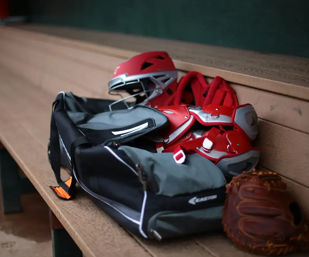 Sports equipment over a bench after a game.