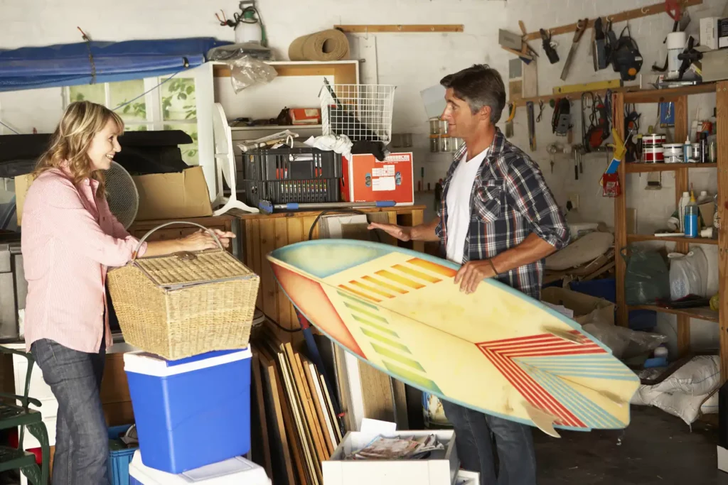 Couple in organizing garage. 