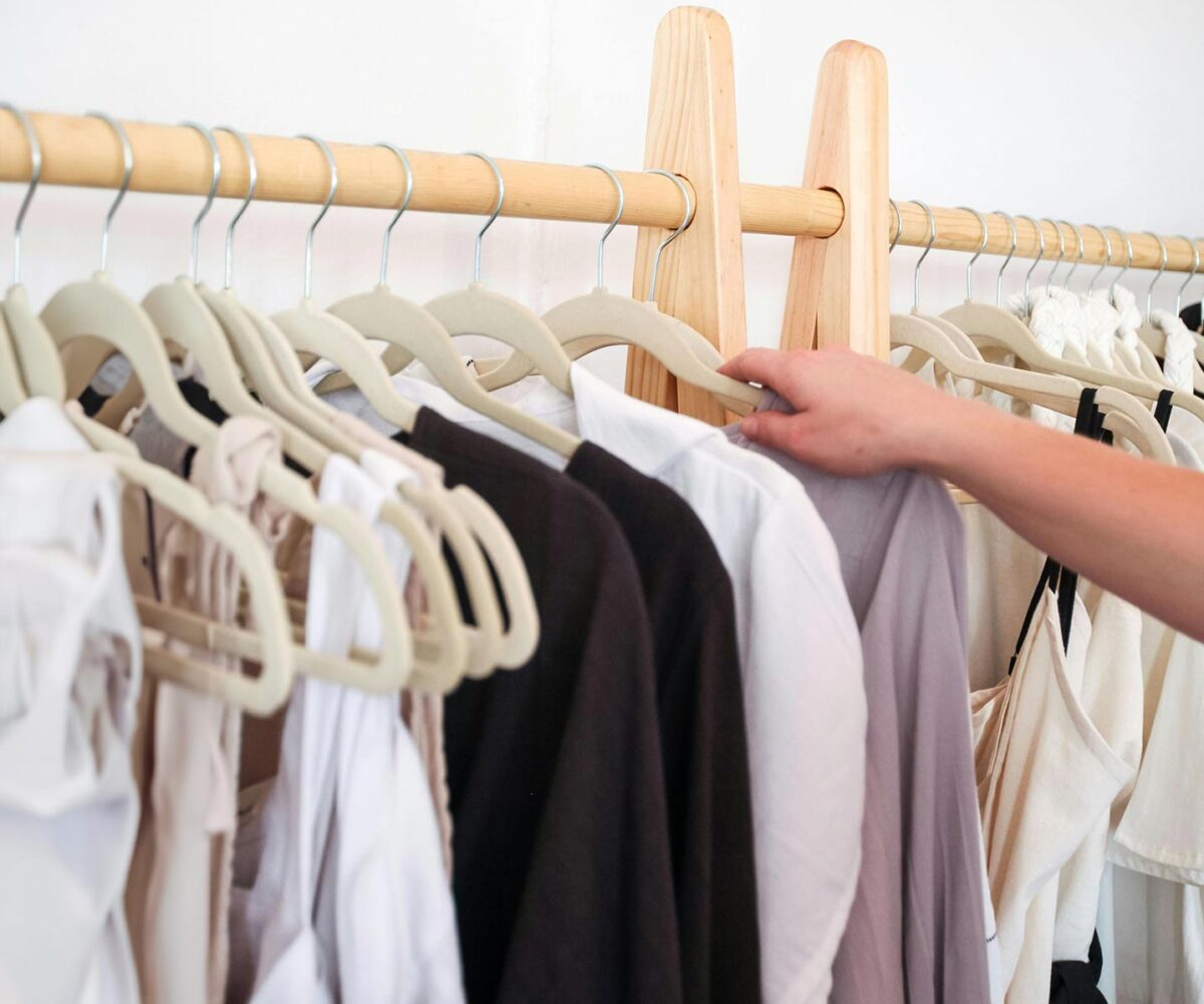 putting clothes on hangers to store for the fall.