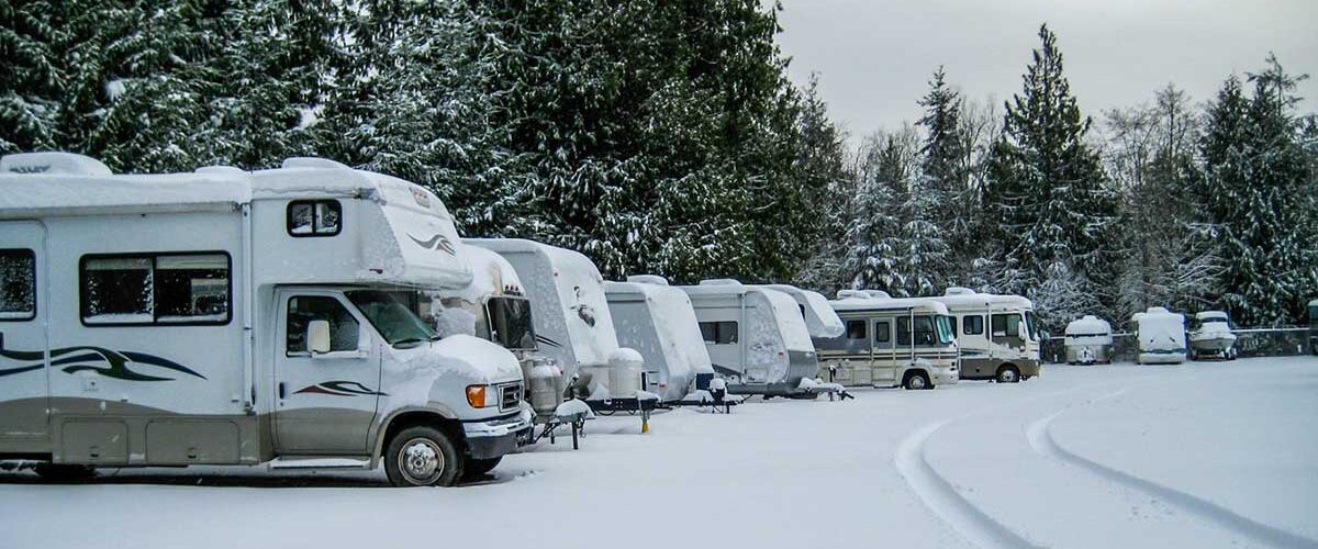 RVs parked during a winter storm.