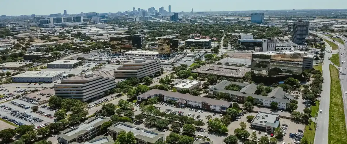 Busy highway traffic on I-35 near the Dallas Medical District and Love Field neighborhood on a sunny day.