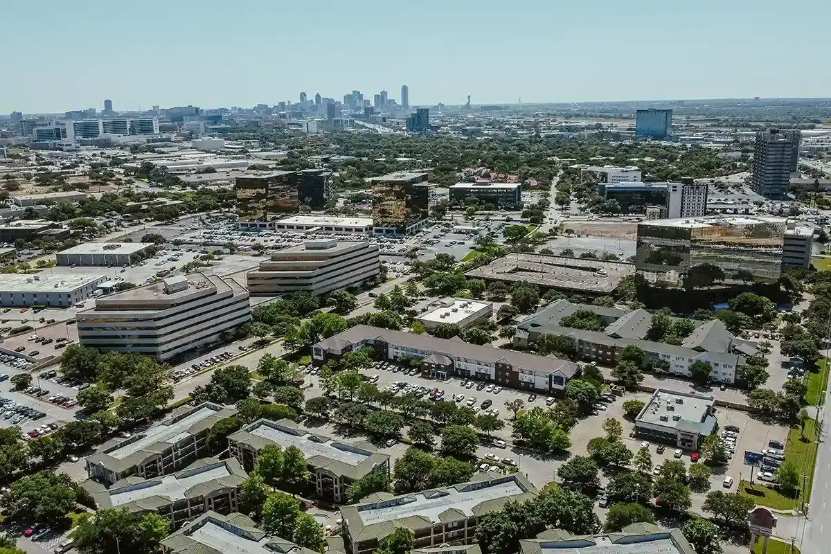 Busy highway traffic on I-35 near the Dallas Medical District and Love Field neighborhood on a sunny day.