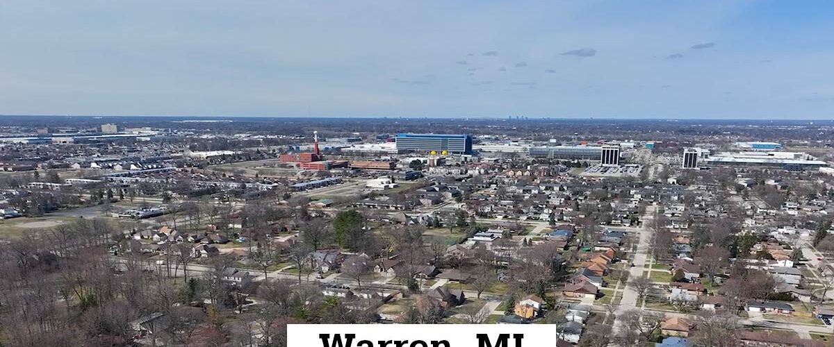 Aerial drone view of Warren, MI, showing the city with housing areas and surrounding commercial area.